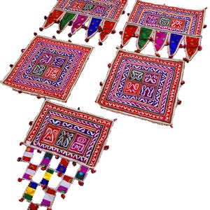 May include: Set of five colorful embroidered fabric wall hangings with tassels. Each hanging features a square design with intricate patterns in shades of red, pink, purple, blue, green, and yellow.