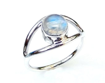 May include: A silver ring with a round, iridescent moonstone set in a delicate, open design.