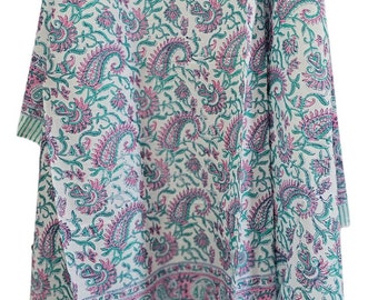 May include: White fabric with a repeating paisley pattern in teal and pink. The fabric has a border with a striped design in teal. The paisley pattern includes floral and teardrop shapes.