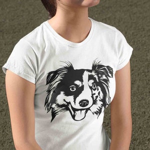May include: A white t-shirt with a black and white illustration of a dog's head. The dog has floppy ears and a happy expression.