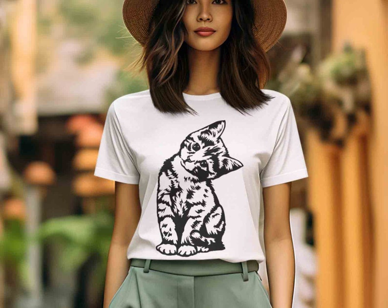 May include: A white t-shirt with a black and white illustration of a cat looking over its shoulder.