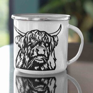 May include: White enamel mug with a black and white illustration of a Highland cow with long horns and a shaggy mane.