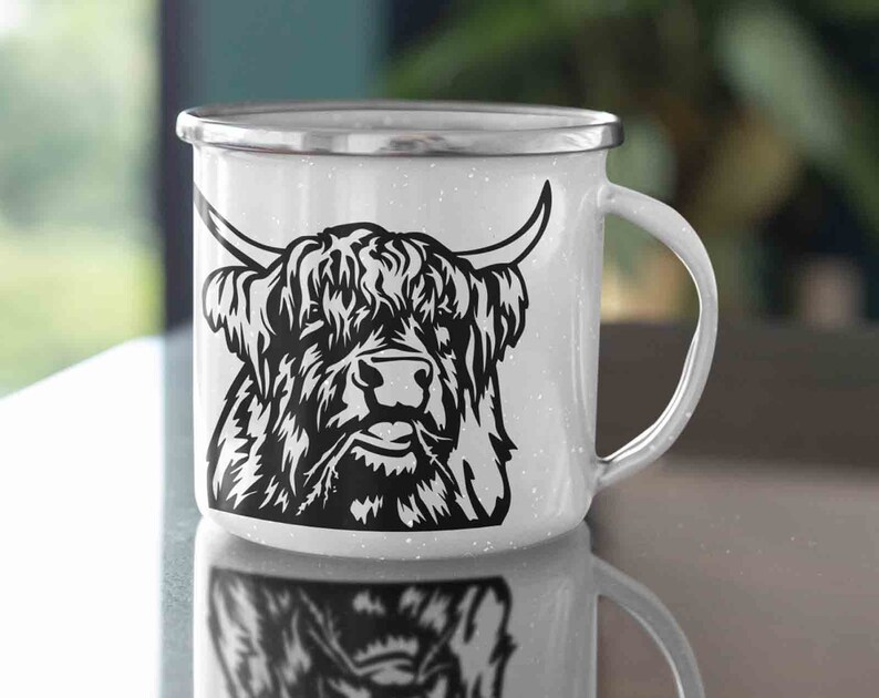 May include: White enamel mug with a black and white illustration of a Highland cow with long horns and a shaggy mane.