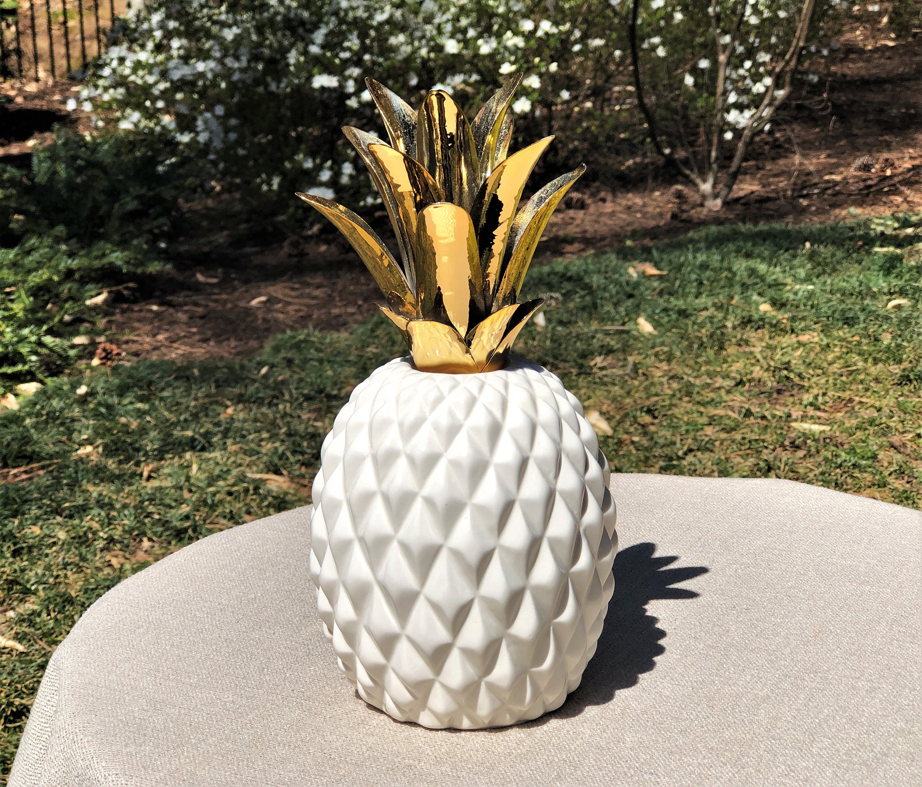 White Ceramic Pineapple Sculpture With Gold Metal Leaves photo