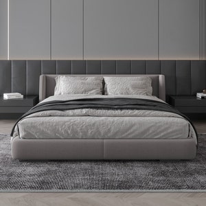 May include: A gray upholstered bed frame with a white linen duvet and black throw blanket. The bed is on a black and white patterned rug in a modern bedroom.