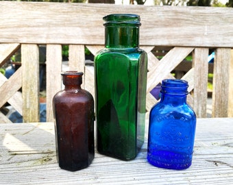 A delectable family of found vintage coloured bottles