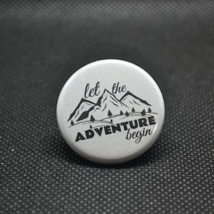Let the adventure begin button, environmentalist buttons, camping buttons, nature buttons, mountain pin, nature pin, camping pin
