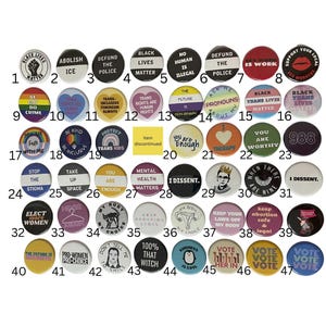 May include: A collection of forty-seven circular pin-back buttons arranged in a grid, each featuring unique text and graphic designs related to social justice, political activism, and personal empowerment, numbered one through forty-seven.