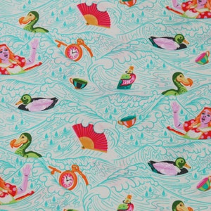 May include: A teal blue fabric with a repeating pattern of a dodo bird, a duck, a woman with red hair, a teacup, a bottle, a fan, and a clock. The background is a light beige color.