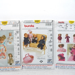 May include: Three Burda doll clothes sewing pattern packets. The packets show images of dolls in various outfits, including dresses, coats, and hats. The packets have the numbers 8308, 8591, and 7753 printed on them.