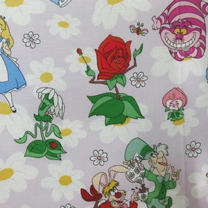 May include: Fabric featuring characters and elements from Alice in Wonderland. The design includes Alice, the Cheshire Cat, a red rose, and other whimsical characters, set against a backdrop of white daisies on a lavender background.