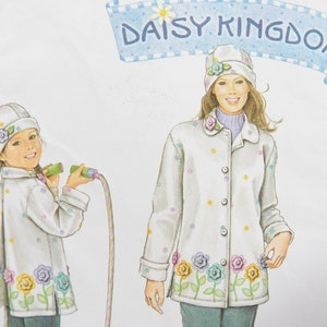 May include: Illustration of a woman and a child wearing matching white jackets and hats, adorned with colorful flower and dot patterns. The jackets have a floral border. The banner above reads "DAISY KINGDOM".