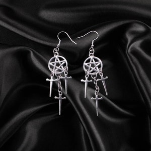 May include: Silver earrings with a pentagram charm and three dangling sword charms.