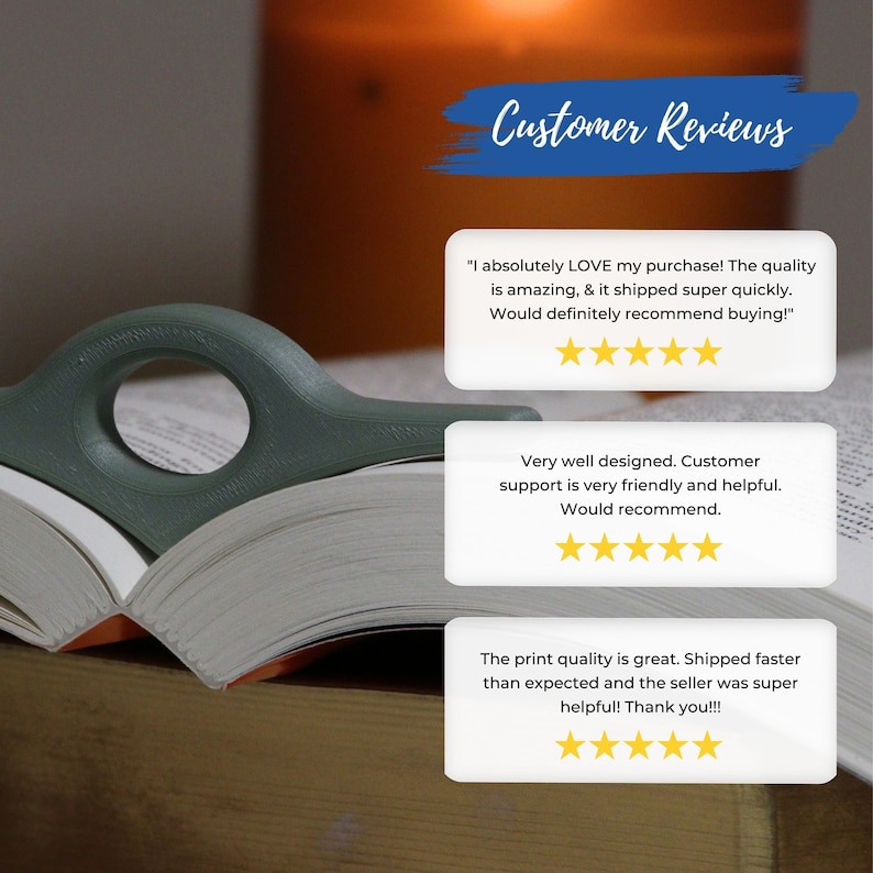 May include: A green book page holder rests on an open book. The holder has a curved design with a circular opening. Customer reviews are displayed in the background, with text and star ratings.