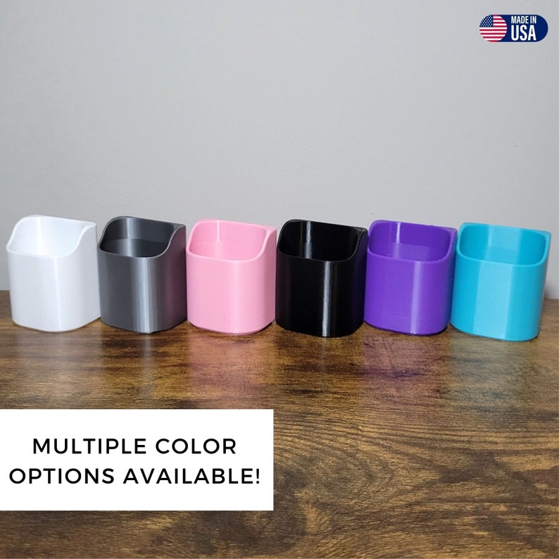 May include: A row of six small, open-top containers in various colors: white, gray, pink, black, purple, and turquoise. The containers are made of a 3D-printed material and sit on a wooden surface. Text at the bottom reads "MULTIPLE COLOR OPTIONS AVAILABLE!"