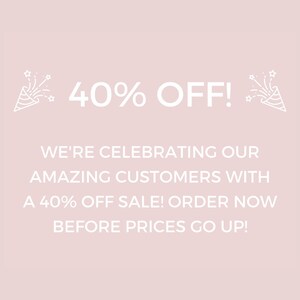 May include: A pink background with white text that reads "40% OFF!" and "WE'RE CELEBRATING OUR AMAZING CUSTOMERS WITH A 40% OFF SALE! ORDER NOW BEFORE PRICES GO UP!" There are two white party poppers with stars on the left and right sides of the text.