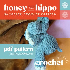 May include: A light blue crocheted hippo plush toy with white accents on its feet and snout. The image includes text that reads "honey the hippo snuggler crochet pattern" and "pdf pattern digital download crochet by cate".