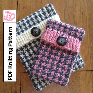 May include: Two knitted phone cases with a houndstooth pattern. One case is black and white, and the other is pink and black. Both cases have a button closure.
