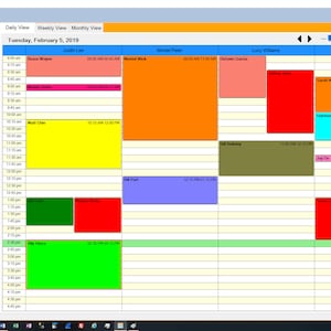 May include: Screenshot of a daily appointment calendar for Tuesday, February 5, 2019. The calendar displays time slots and appointment details for various individuals, with color-coded blocks representing scheduled events. The interface includes a date selector and resource list.