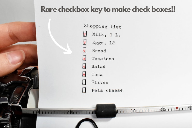 May include: A shopping list typed on a typewriter, with check boxes. The list includes milk, eggs, bread, tomatoes, salad, tuna, olives, and feta cheese. The text "Rare checkbox key to make check boxes!!" is at the top.