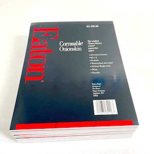 May include: A stack of Eaton Corrasable Onionskin typewriter paper in a dark blue package with red text. The packaging lists 25% cotton content, 8.5 x 11 inch dimensions, 50 sheets, medium weight 16 lb, white color, and erasable features.