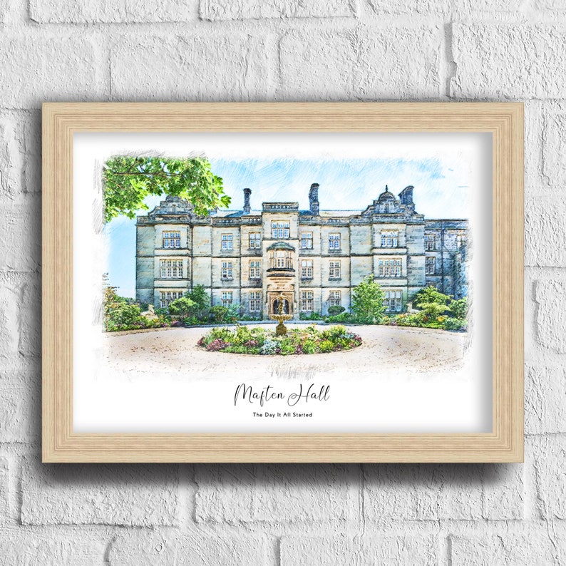 May include: A framed print of Marten Hall, a large stone building with many windows and a central entrance. The artwork is a watercolor-style illustration with a light wood frame. The text "Marten Hall" and "The Day It All Started" are below the image.