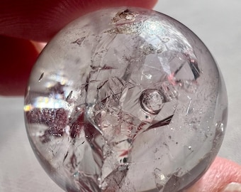 Enhydro - quartz rock crystal shaped as a sphere ball with a moving bubble - phantom and superb internal crystal formation - ID A0448