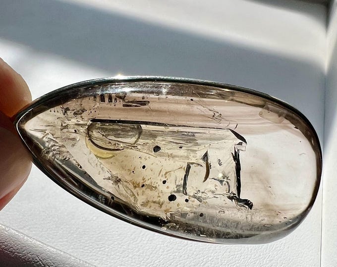 Enhydro silver pendant with a large moving bubble, hematite inclusion and UV reactive substance - quartz rock crystal - ID A0670