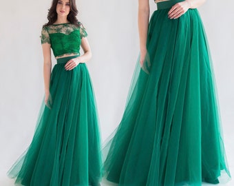 May include: A green tulle skirt with a lace top. The skirt is full and flowing, and the top is fitted with short sleeves.