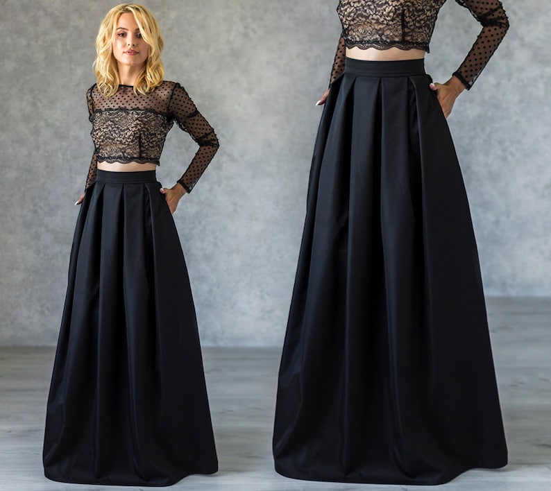 Stylish floor length black skirt with a wide pleats. Waist fit, has a sewn-in waistband about two inches wide. Made of polished cotton, with a slight sheen. Pockets in the side seams. Hidden zip fastening at the back.