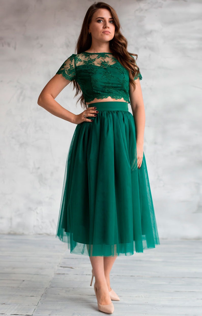 Fluffy tutu emerald tulle skirt. Midi length, waist fit. Has a sewn-in waistband about two inches wide. Sewn from several layers of soft tulle, lined with chiffon. Very flowy and airy.