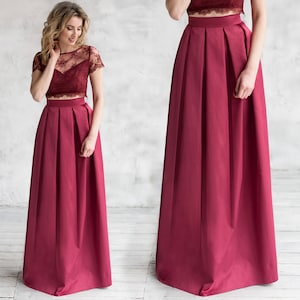 Stylish floor length burgundy skirt with a wide pleats. Waist fit, has a sewn-in waistband about two inches wide. Made of polished cotton, with a slight sheen. Pockets in the side seams. Hidden zip fastening at the back.