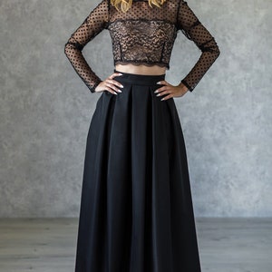 Stylish floor length black skirt with a wide pleats. Waist fit, has a sewn-in waistband about two inches wide. Made of polished cotton, with a slight sheen. Pockets in the side seams. Hidden zip fastening at the back.