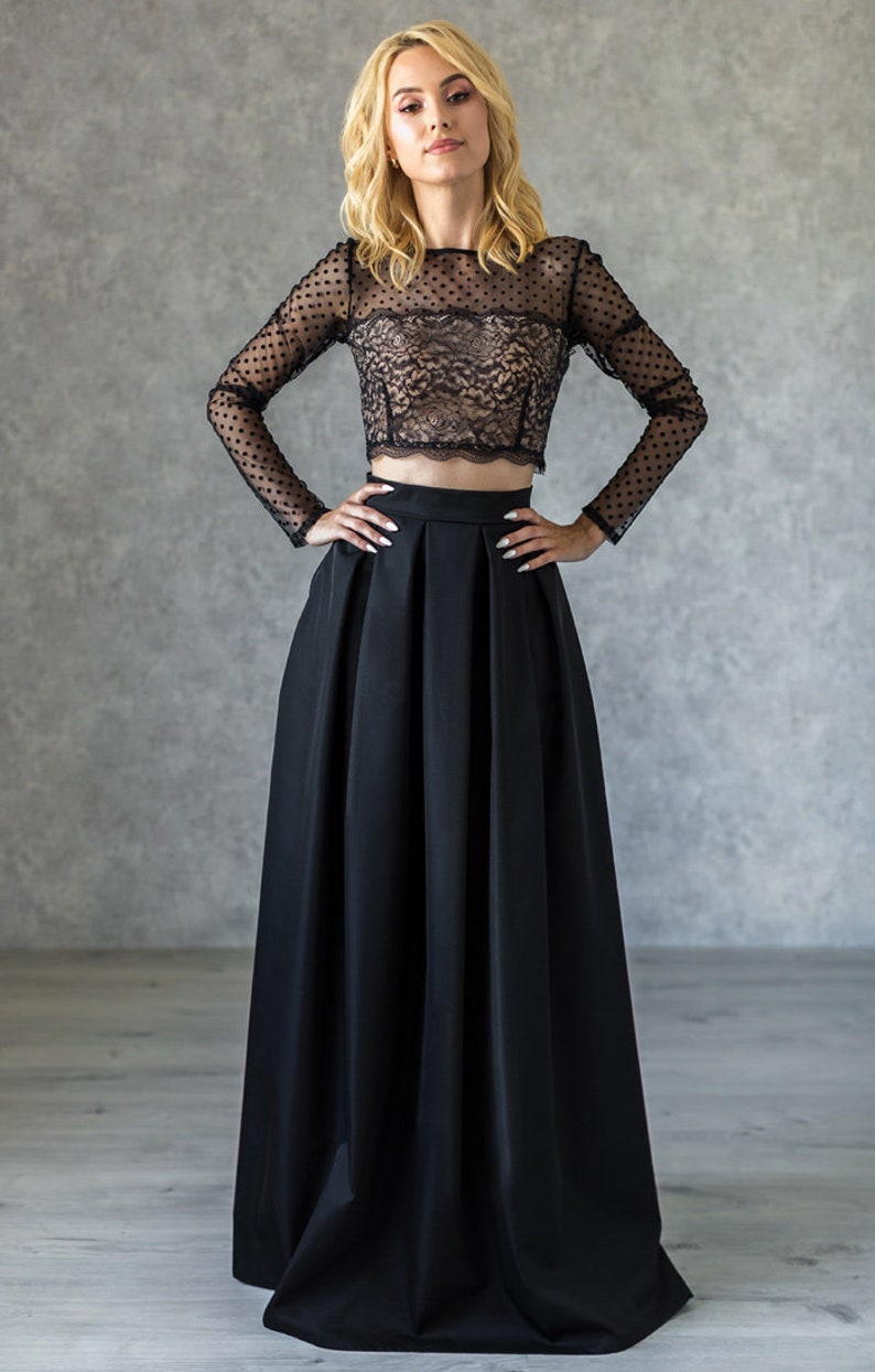 Stylish floor length black skirt with a wide pleats. Waist fit, has a sewn-in waistband about two inches wide. Made of polished cotton, with a slight sheen. Pockets in the side seams. Hidden zip fastening at the back.