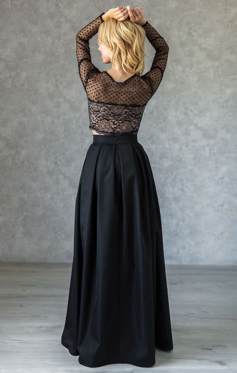 Stylish floor length black skirt with a wide pleats. Waist fit, has a sewn-in waistband about two inches wide. Made of polished cotton, with a slight sheen. Pockets in the side seams. Hidden zip fastening at the back.