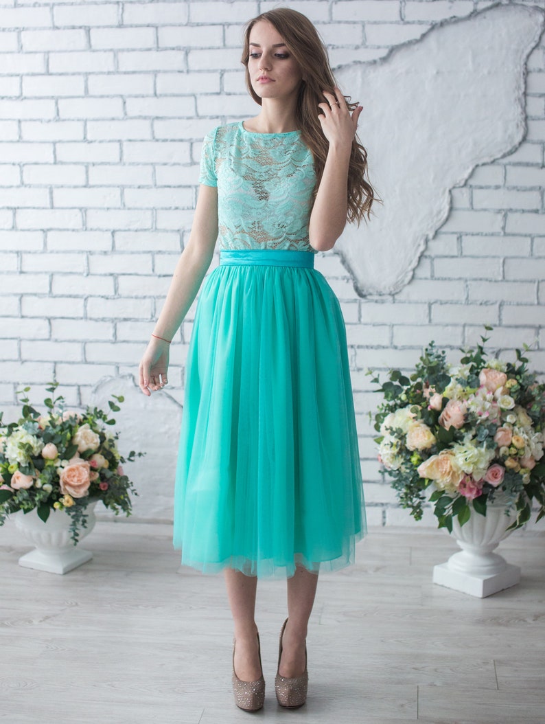 Fluffy tutu mint tulle skirt. Midi length, waist fit. Has a sewn-in waistband about two inches wide. Sewn from several layers of soft tulle, lined with chiffon. Very flowy and airy.