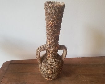 Terracotta amphora vase and glued shells