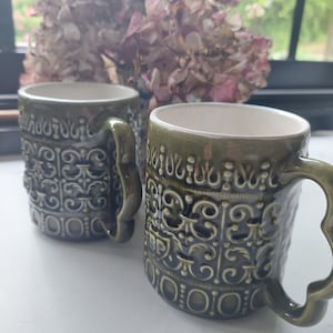 2 BP advertising mugs in olive green slip, 70s