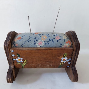 Wooden pincushion in the shape of a cradle