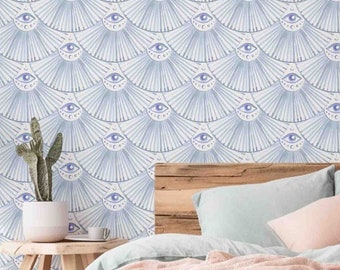 May include: A light blue and white patterned wallpaper with a design of stylized eyes. A bed with a light blue duvet cover and a pink throw blanket is in front of the wallpaper. The bed has a wooden headboard and two pillows. There are two small wooden side tables with potted cacti on them.