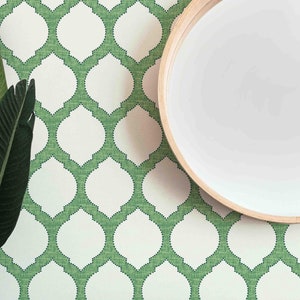 May include: Green and white patterned wallpaper with a round mirror and a small potted plant on a wooden shelf.