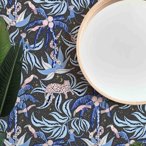 May include: A dark gray wallpaper with a repeating pattern of blue and white palm trees, pink toucans, monkeys, snakes, and leopards. The wallpaper is accented with gold stars and a crescent moon.