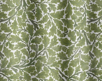 May include: A white fabric with a repeating pattern of green oak leaves and acorns. The leaves are stylized and have a slightly textured appearance.