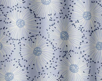 May include: A pale blue fabric featuring a repeating floral design. Large white flowers with blue centres and thin, curved lines are spread across the material. Small, dark blue dots fill the spaces between the flowers.