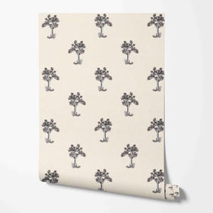 May include: A roll of wallpaper with a repeating pattern of stylised trees in grey and black. The trees have rounded tops and thin trunks, set against a cream background. The wallpaper is partially rolled.