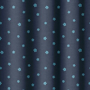 May include: Dark navy fabric featuring a repeating pattern of small, light blue floral designs. The fabric has a subtle texture and is slightly gathered, creating soft vertical folds. The overall effect is a delicate, floral pattern.