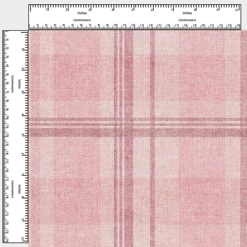 May include: A close-up of a pink plaid fabric with a woven texture. The pattern features intersecting lines in varying shades of pink and white, with measurements in inches and centimeters.