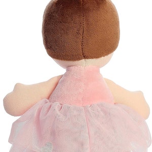 May include: A plush ballerina doll with brown hair in a bun, wearing a pink dress and a tulle skirt.