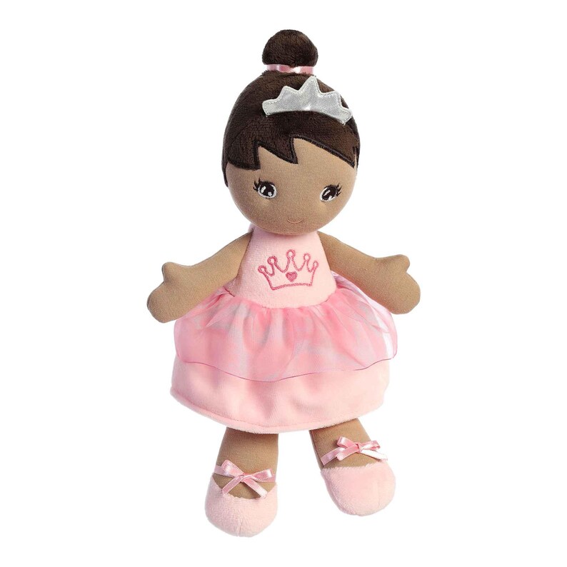 May include: A brown-skinned plush doll wearing a pink tulle ballerina dress with a crown and heart embroidery. The doll has brown hair and a silver crown on her head.