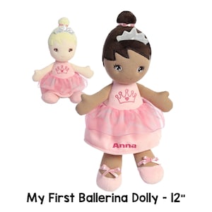 May include: Two 12-inch plush ballerina dolls. One doll has blonde hair and a pink dress with a crown. The other doll has brown hair and a pink dress with a crown and the name "Anna" embroidered on it.